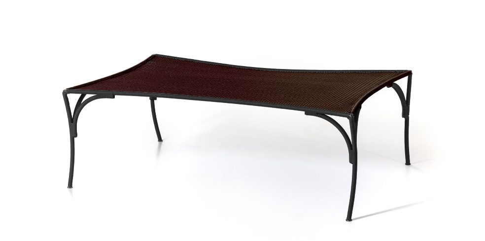 Arch Table by Moroso featuring sculptural arched base and sleek tabletop, front view in Royal Oak Michigan showroom