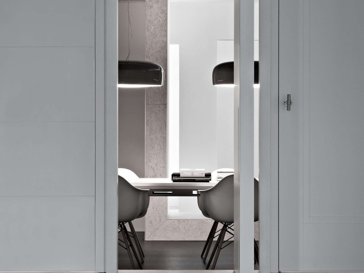 Side profile of a red Smithfield Suspension light, showcasing its smooth painted steel shade and bright white opal diffuser.