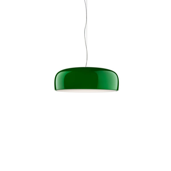 Smithfield Suspension by Flos, Green Smithfield Suspension pendant in gloss finish, its wide aluminum shade hanging low over a dining table against a concrete wall.