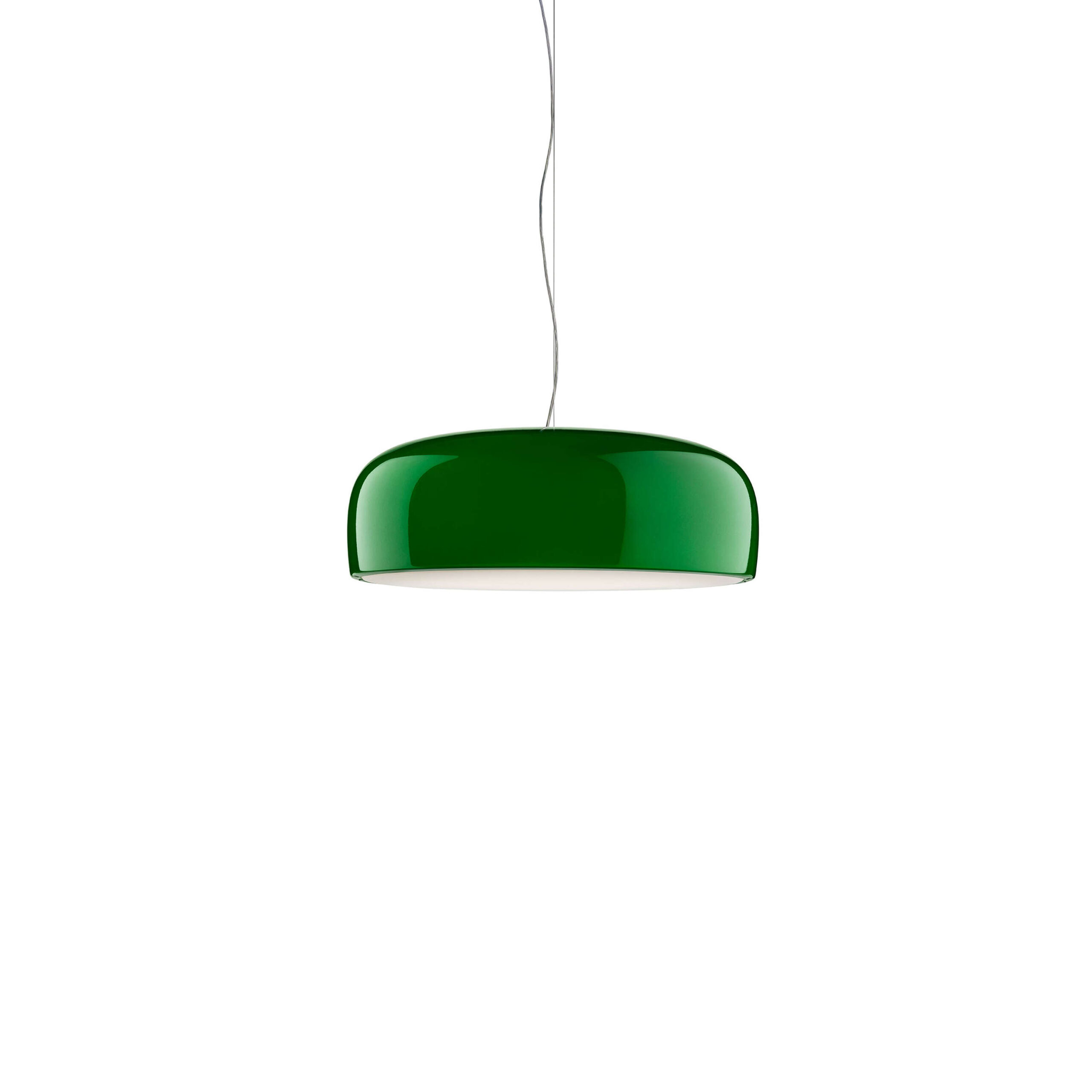 Smithfield Suspension by Flos, Green Smithfield Suspension pendant in gloss finish, its wide aluminum shade hanging low over a dining table against a concrete wall.