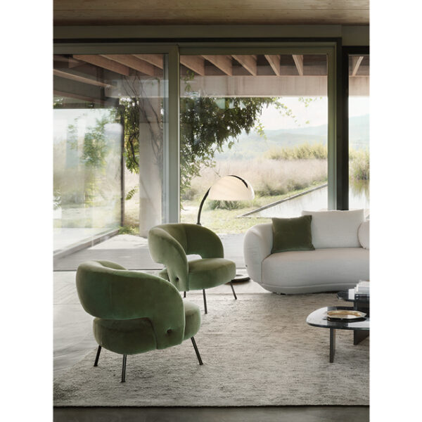 Soufflé armchair by Nicoline, featuring a curved silhouette and eco-friendly foam, adding retro elegance to interiors in Royal Oak, Michigan.
