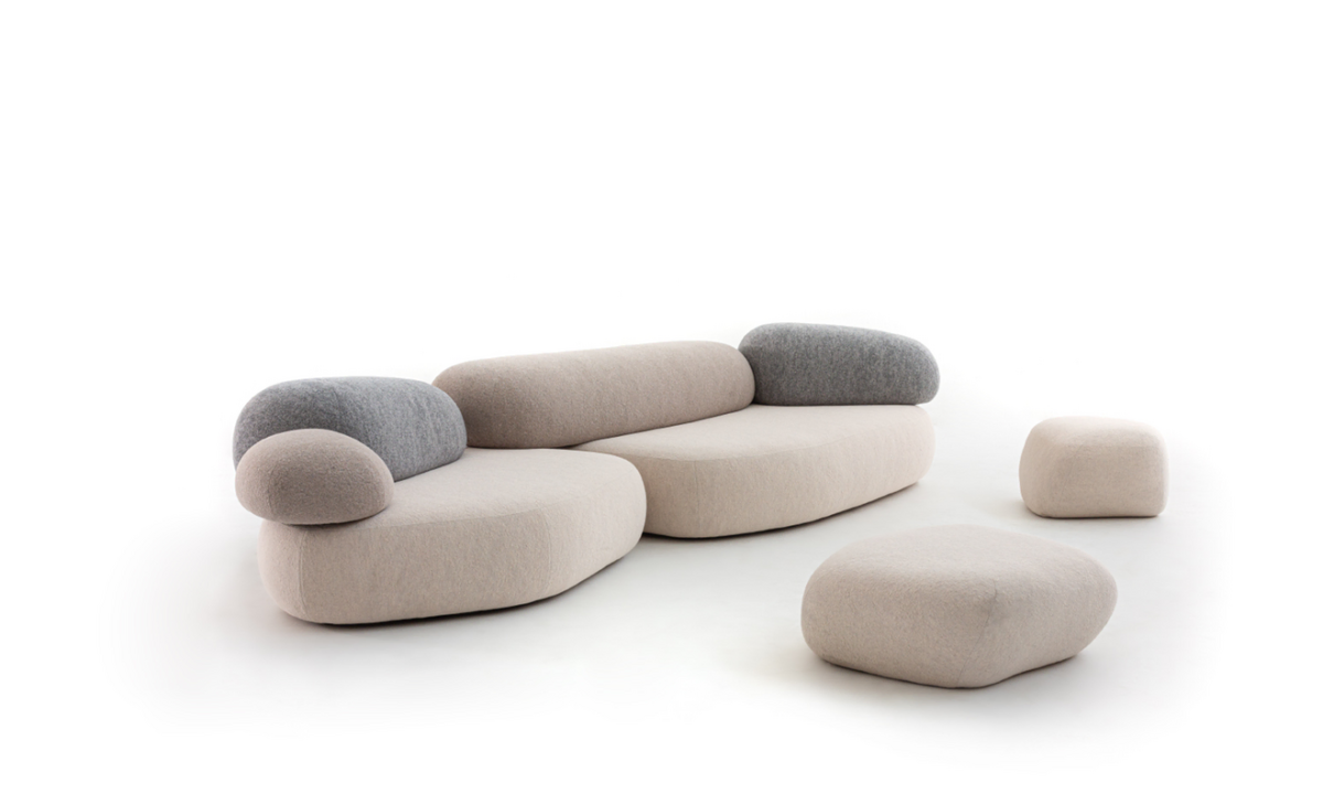 Modern sculptural sofa with a low, earthy silhouette, Pebble Rubble by Moroso arranged in a curved formation.