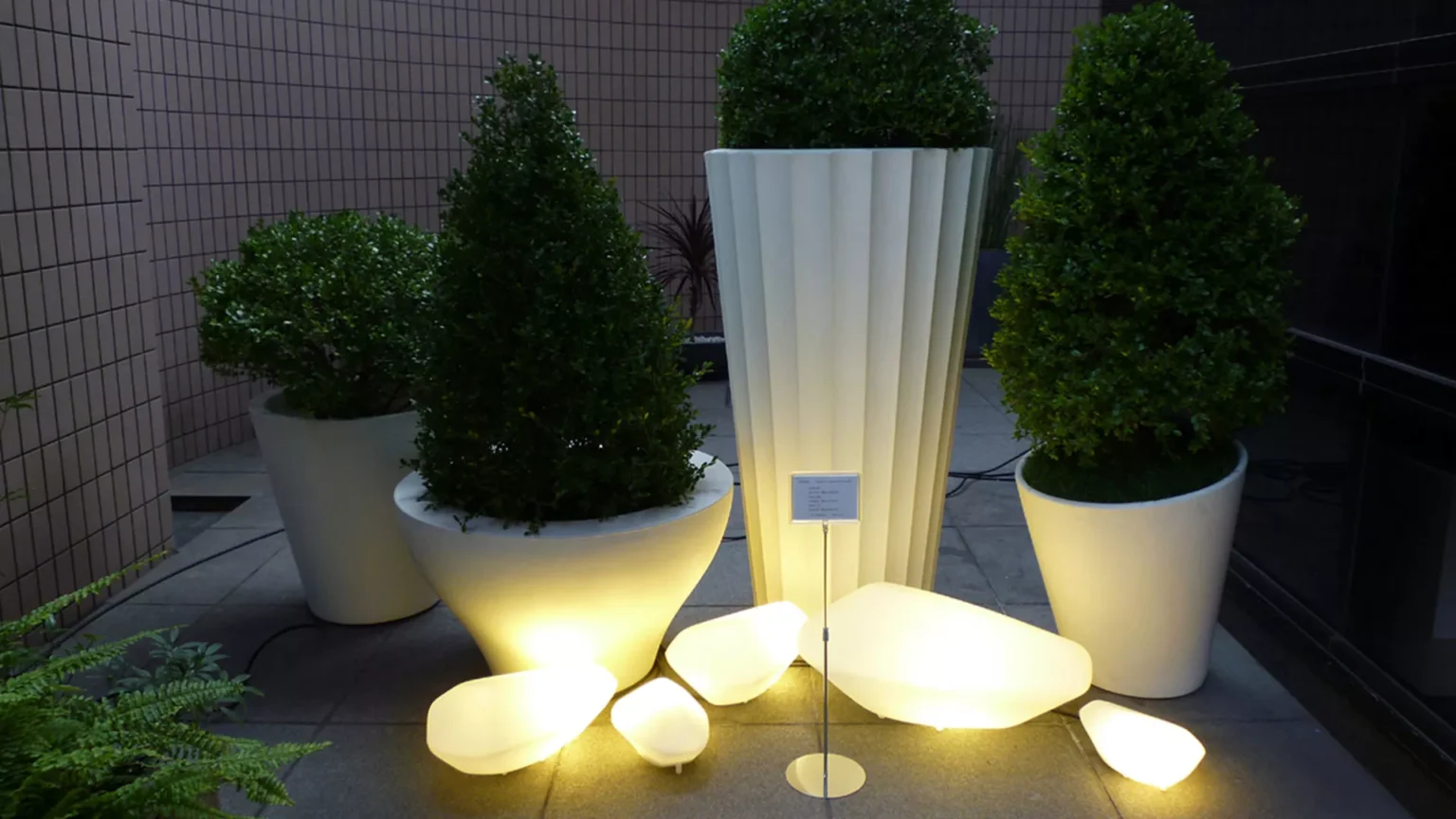 “Stones Outdoor by Oluce contemporary exterior light – organic stone-inspired outdoor lamp with soft glowing light and weather-resistant design”