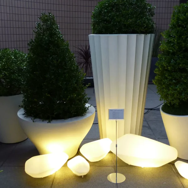 “Stones Outdoor by Oluce contemporary exterior light – organic stone-inspired outdoor lamp with soft glowing light and weather-resistant design”