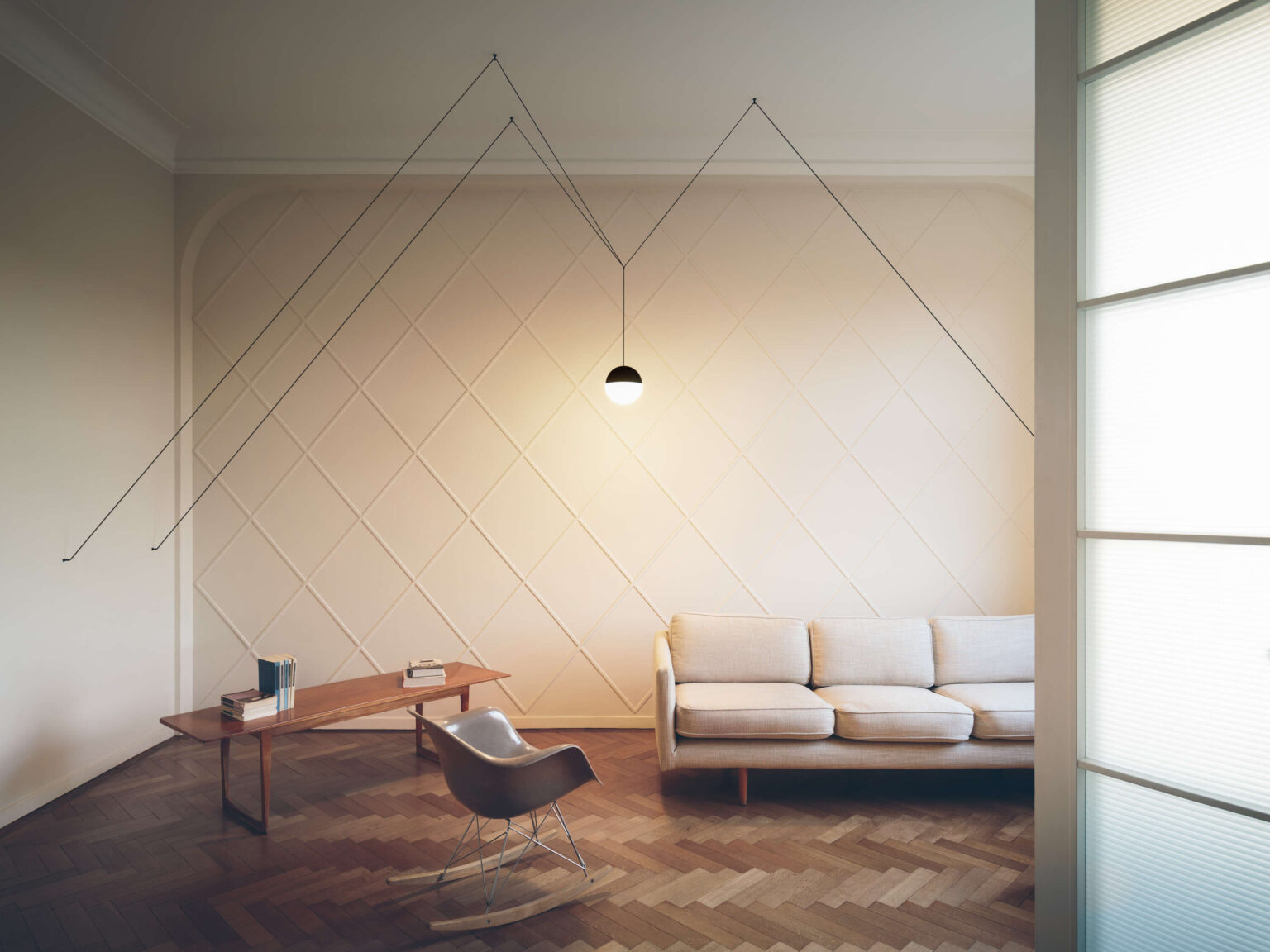 Round pendant light hanging from a long black cord.