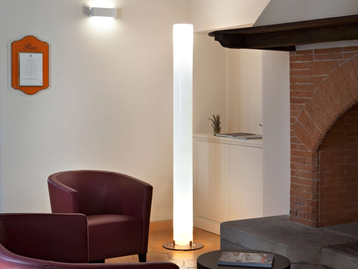 Superloon Floor Lamp by Flos showcasing its gyroscopic spinning head and slim painted aluminum body at the Michigan Design Center