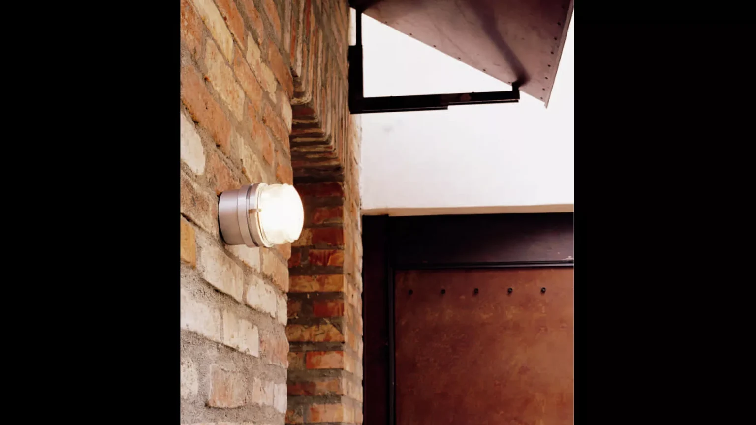 “Fresnel by Oluce contemporary designer lighting – directional floor lamp featuring cylindrical head and polished metal finish”