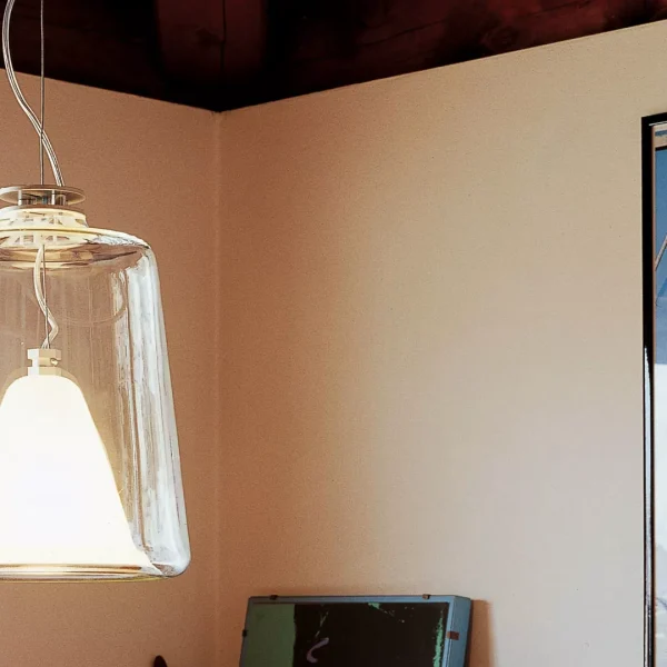 “Lanterna by Oluce modern Italian lantern-style table lamp – elegant glass enclosure with metal frame and warm ambient light”