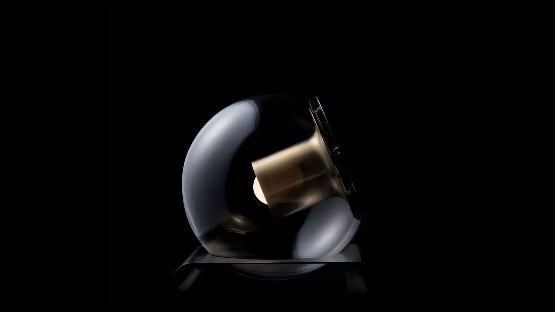 “The Globe by Oluce modern Italian table lamp – transparent glass sphere with suspended inner diffuser and chrome base”