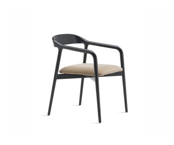 "Velasca Armchair by Casamania featuring a sculptural solid ash wood frame with a padded seat upholstered in beige fabric."