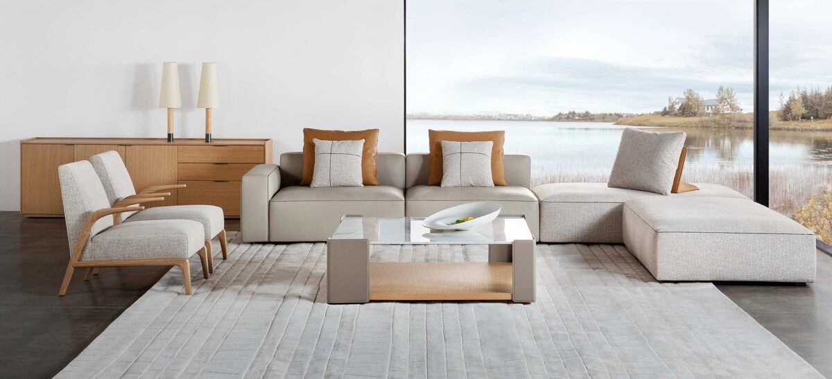 Elegant upholstered chair with curved backrest and sleek legs by Camerich.