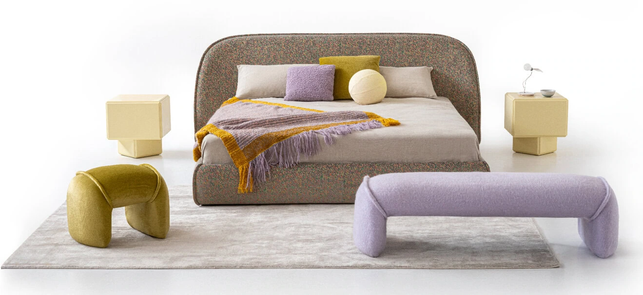 Sedona bed in muted lilac upholstery with rounded headboard and matching base, styled in a warm desert‑inspired bedroom