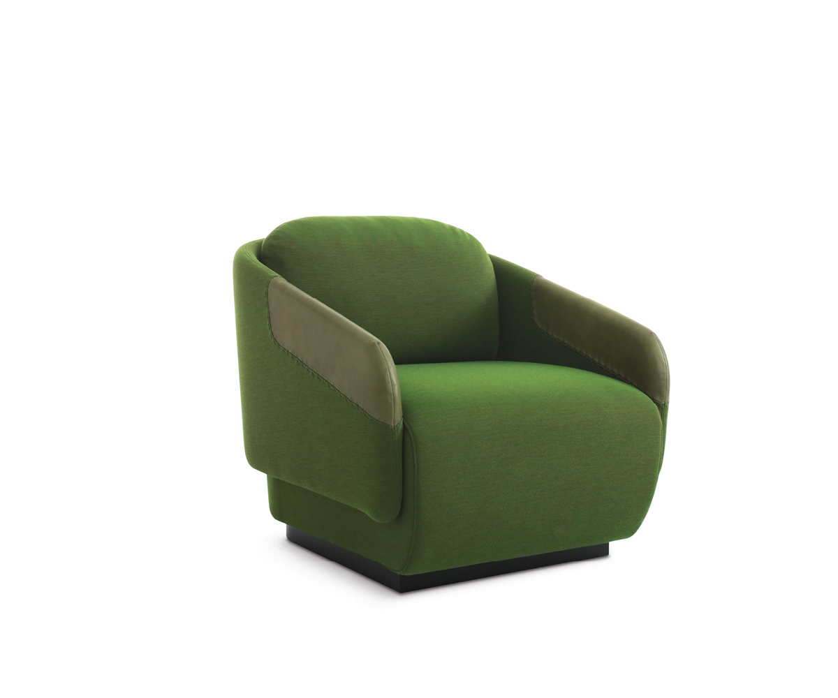"Worn pouf by Casamania in distressed grey fabric, offering casual and cozy seating in a living room."