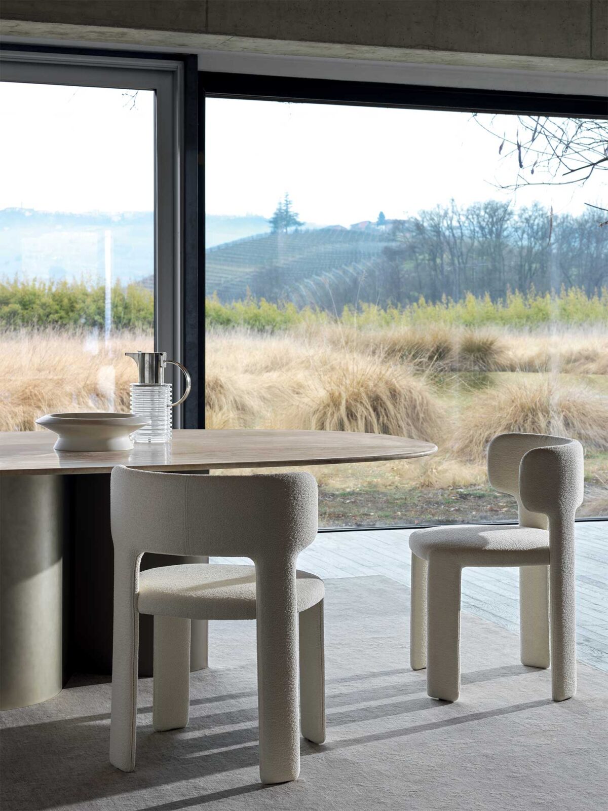 “Lucy chair by Ditre Italia – contemporary Italian lounge chair with curved silhouette and soft fabric upholstery”