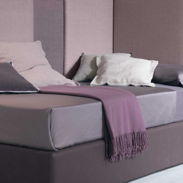 “Corner single bed by Tomasella – modern Italian single bed with wraparound upholstered headboard for corner placement”