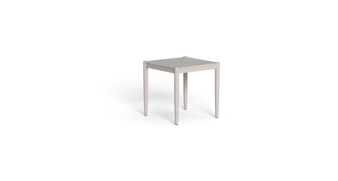 The aluminum structure is often available in finishes like warm white or graphite, while the stoneware top can come in beige or dark gray tones.