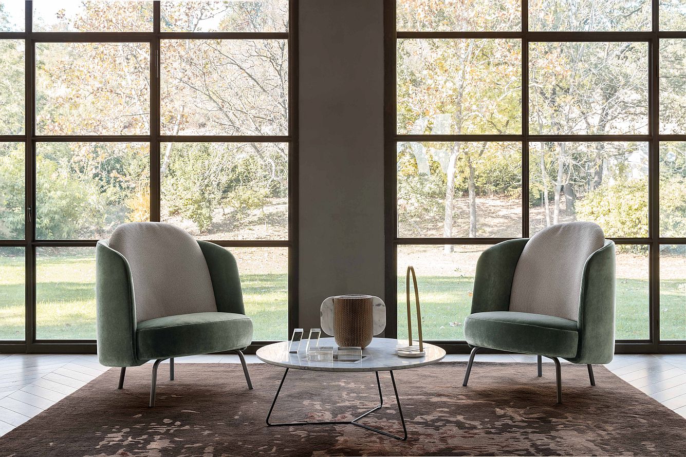 “Ditre Italia LUCIA – modern designer armchair featuring curved silhouette, tailored fabric, and minimalist base”