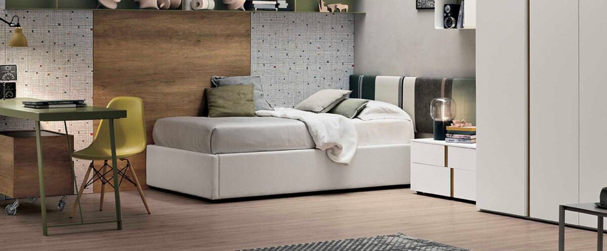 “Diagonal single bed by Tomasella – modern Italian youth bed with angled upholstered headboard and sleek frame”