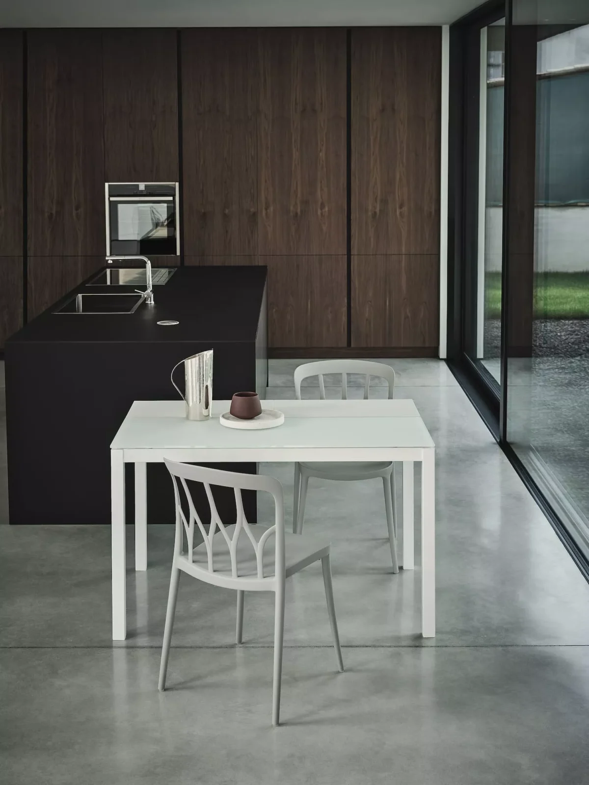 Contemporary kitchen featuring curved Galaxy table by Bontempi