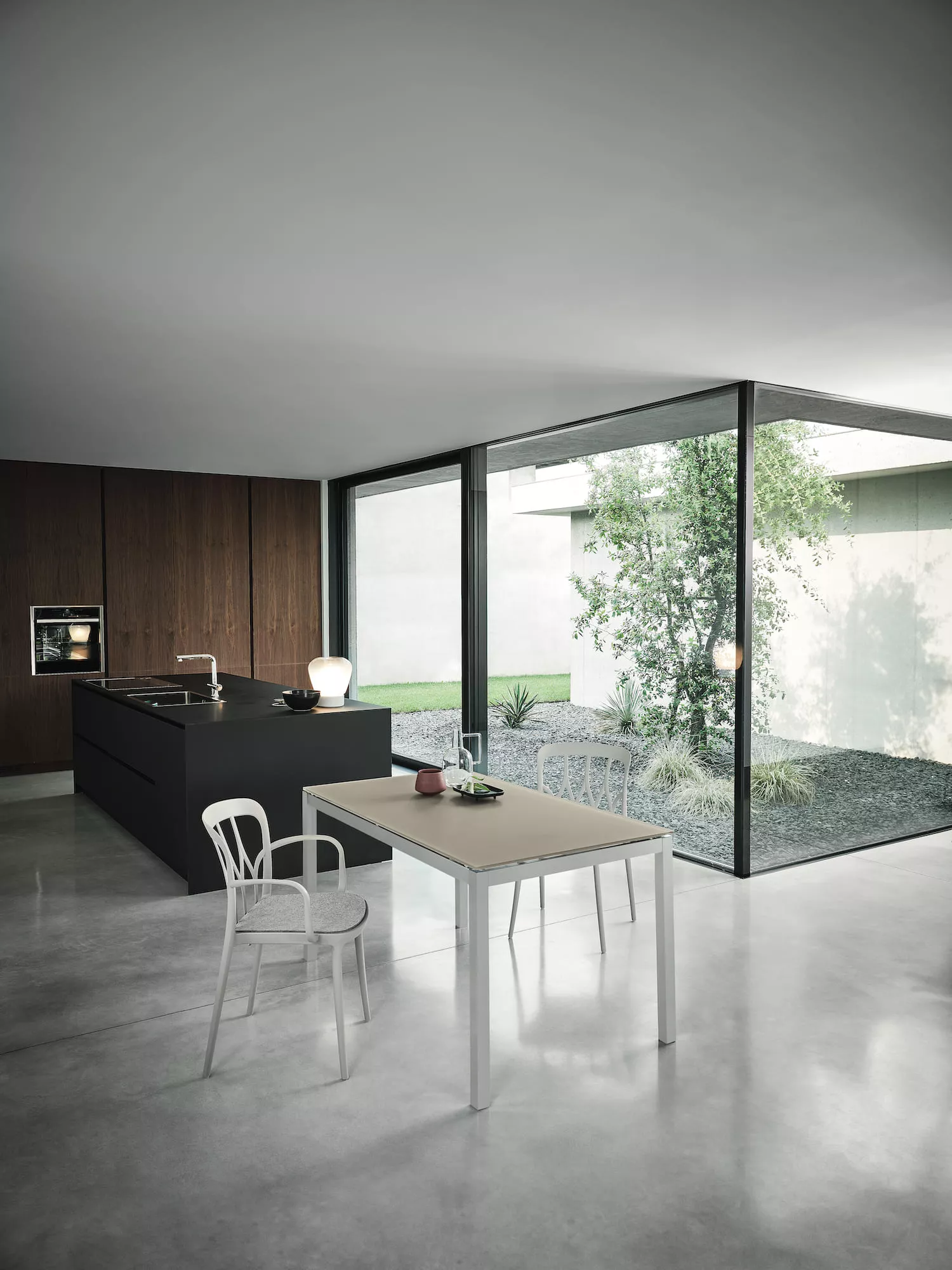 Mango dining table extended to accommodate additional guests, featuring a melamine top and metal frame.