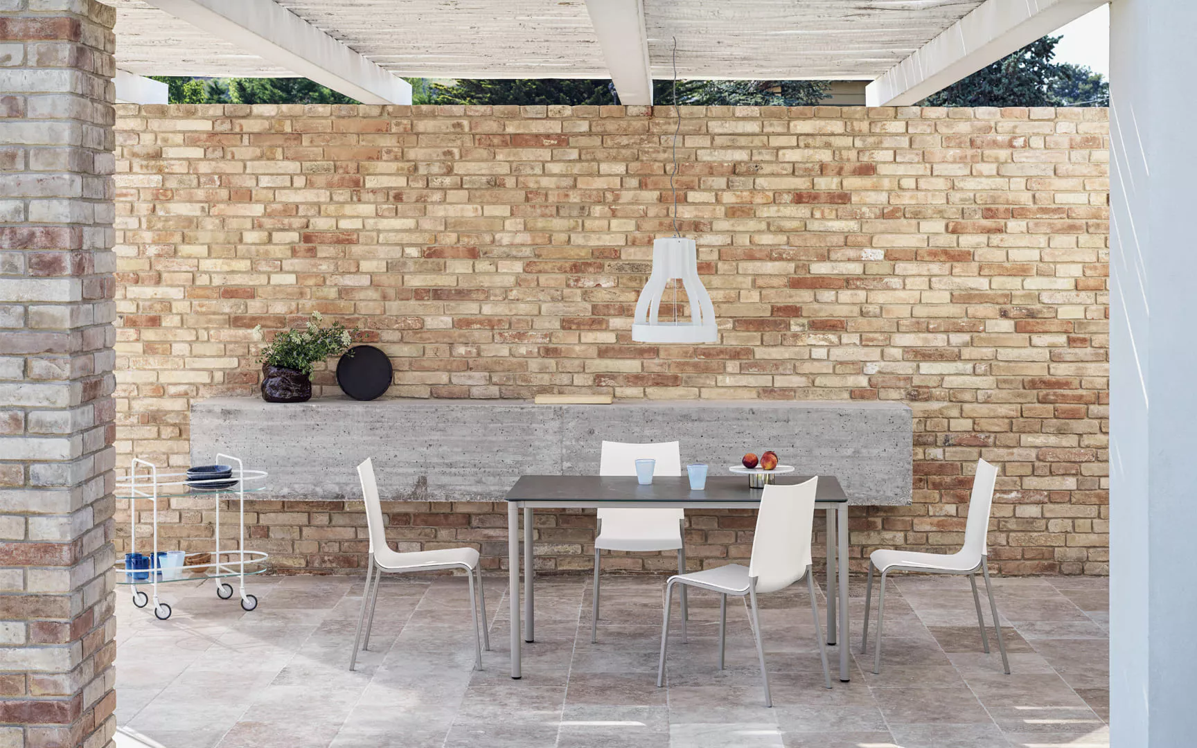 Eva Outdoor dining table by Bontempi in sunlit patio