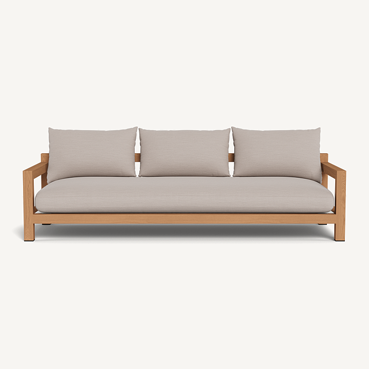 “Side profile of Pacific Teak Sofa – luxury outdoor seating with wide teak arms and weather-resistant fabric”