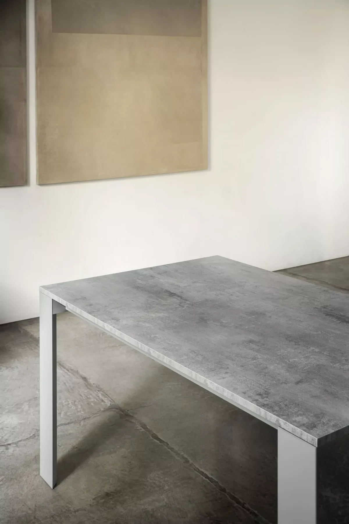 Pascal extendable dining table by Bontempi Casa featuring a sleek metal frame and melamine top in Concrete Sand finish.