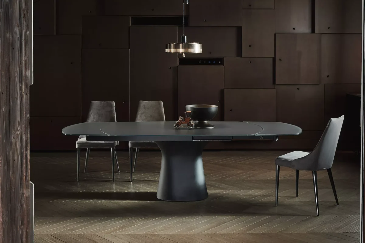 Long Podium by Bontempi dining table (98″ × 45″) with anthracite concrete base and glossy black glass top in a minimalist space.