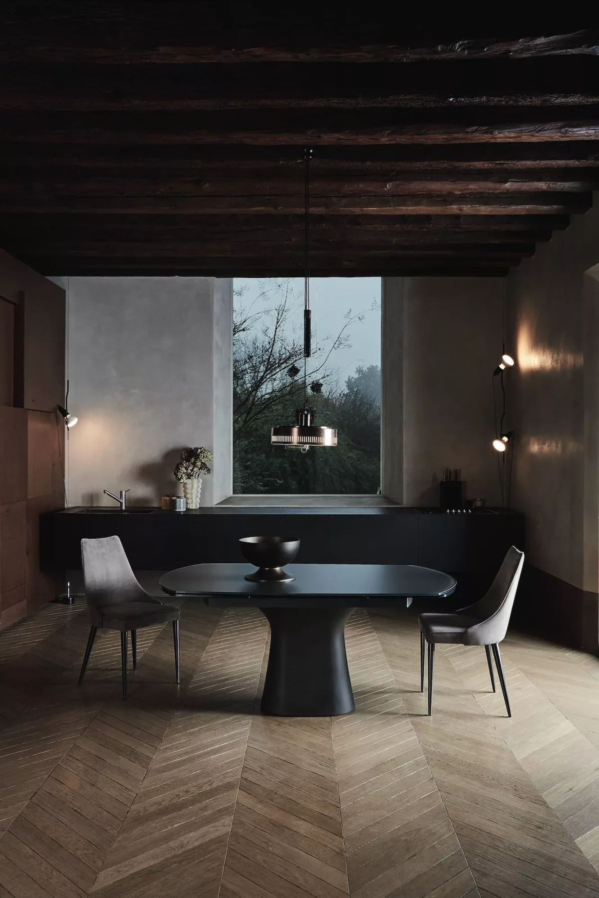 Close-up of Podium by Bontempi showing raw-textured concrete base and polished dove‑grey velvet‑matt glass tabletop.