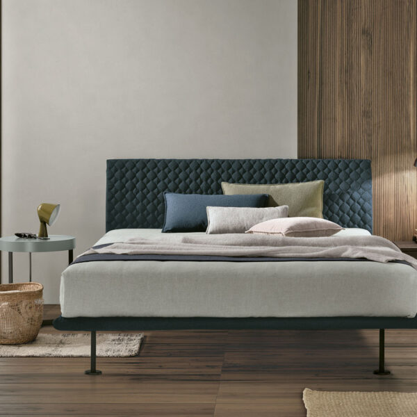 “Tomasella Seven – refined upholstered bed featuring soft fabric finish and modular headboard design”