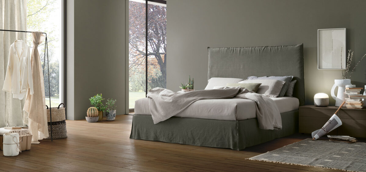 “Hera bed by Tomasella – modern Italian bed with tall upholstered headboard and elegant vertical stitching”