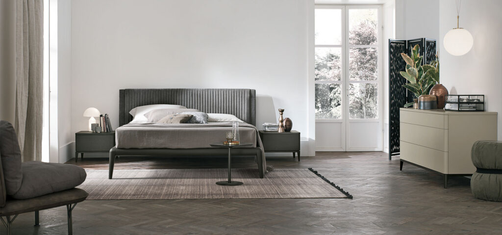 “Marlena bed by Tomasella – modern Italian bed with curved upholstered headboard and soft padded detailing”