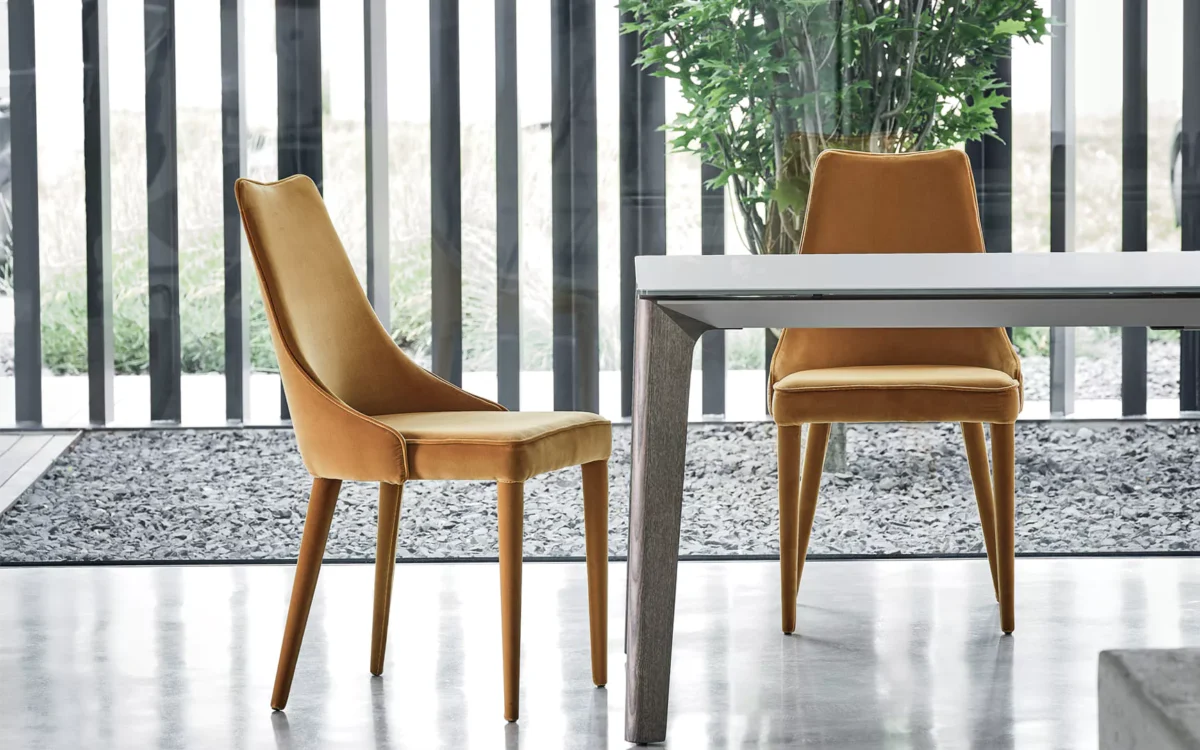 Bontempi Clara seating paired with a glass‑top dining table in open‑plan space