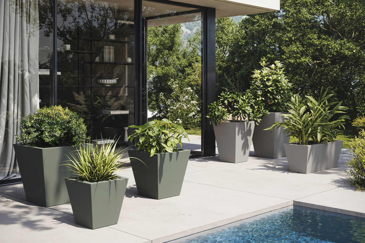 "Outdoor setting featuring Vondom SIMPLE PLANTER with lush greenery."