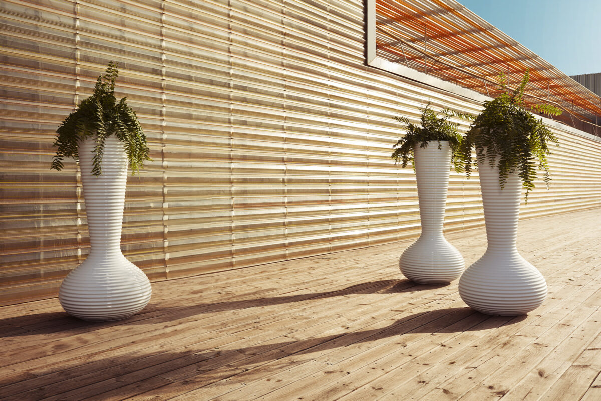 "Large Vondom BLOOM PLANTER in ecru, placed in a contemporary garden setting."
