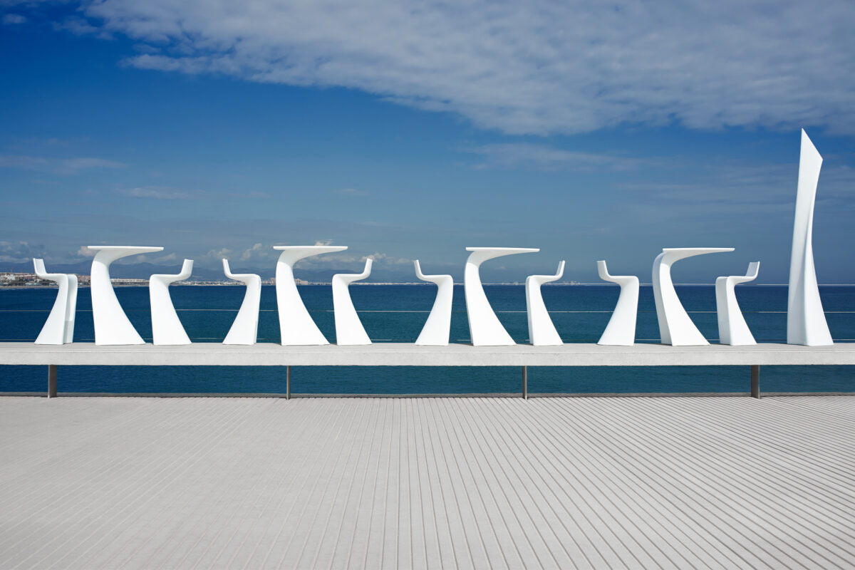 Contemporary WING Bar Table by Vondom with bold curves and high-gloss finish for stylish outdoor spaces