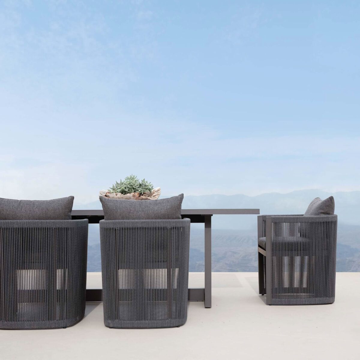 “Antigua outdoor dining chair by Harbour – handwoven rope back with cushioned seat and modern form”
