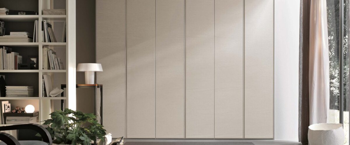 "Tomasella Gola – contemporary bedroom wardrobe featuring clean-lined doors and recessed opening system”