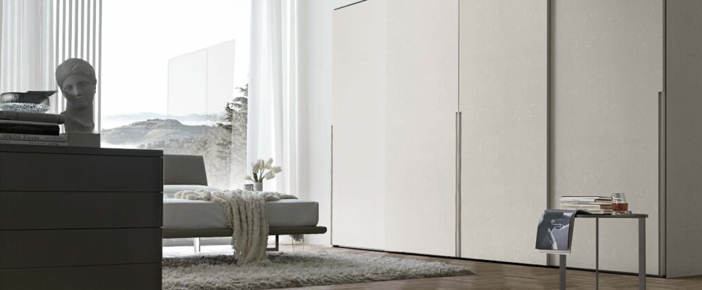 “Doris Sliding wardrobe by Tomasella – modern Italian wardrobe with smooth sliding doors and integrated recessed handles”