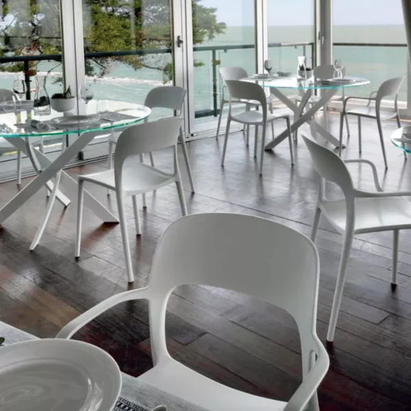 Minimalist interior featuring Barone by Bontempi with smoky‑grey glossy glass top and white lacquered crossed base.