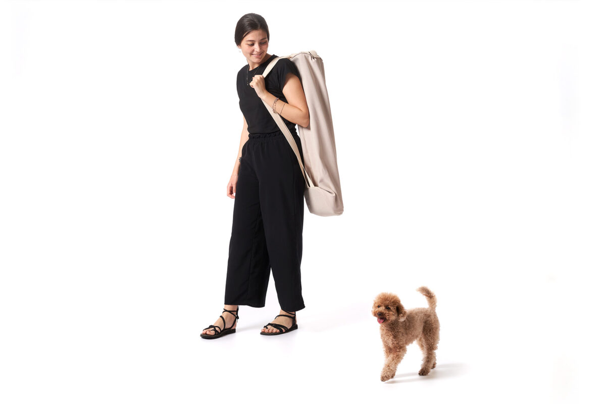 Berberé transportable dog bed by Opinion Ciatti in black leather, featuring a solid ash wood frame and waterproof leather hammock, displayed in Royal Oak, Michigan showroom.