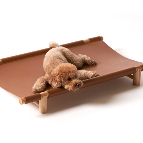 Berberé transportable dog bed by Opinion Ciatti in black leather, featuring a solid ash wood frame and waterproof leather hammock, displayed in Royal Oak, Michigan showroom.