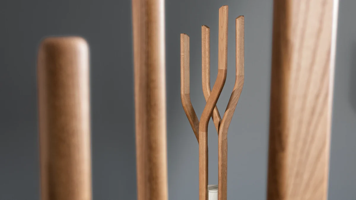 Modern Alma coat rack by Bonaldo combining natural walnut arms with industrial grey or travertine concrete base