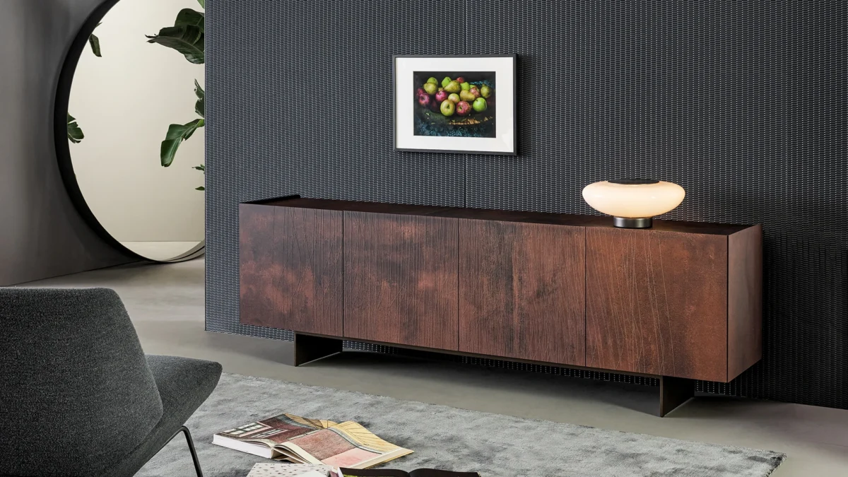 Blush sideboard by Bonaldo with four grooved doors, dark grey melamine interior shelves, and freestanding blade‑base design.