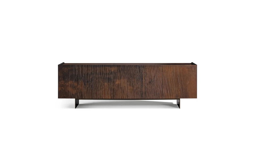 Bonaldo Blush sideboard in corten‑effect wood with abstract relief grooves and bronze or lead double‑blade metal base.