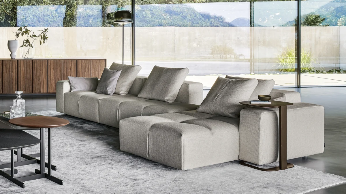 Contemporary Bonamour sofa by Mauro Lipparini, combining linear volume modules, pleated detailing and low metal base.