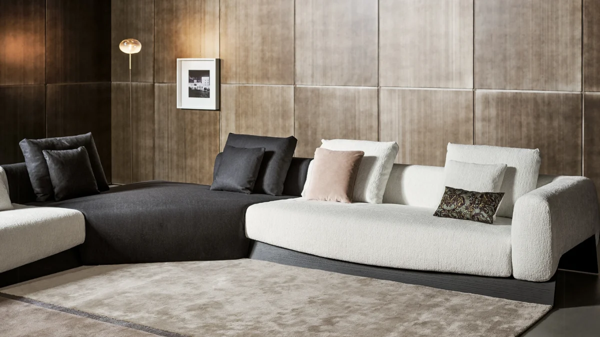 Bonaldo Boolean armchair with enveloping curved shell and solid walnut bridge‑style base