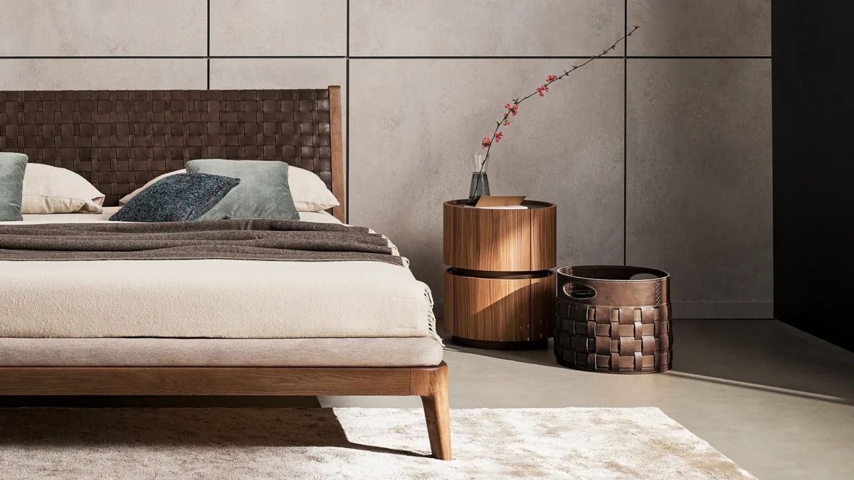 Elegant Moneypenny nightstand by Bonaldo, featuring a curved wooden cylinder with a matte lacquered wood base in bronze or lead finish.