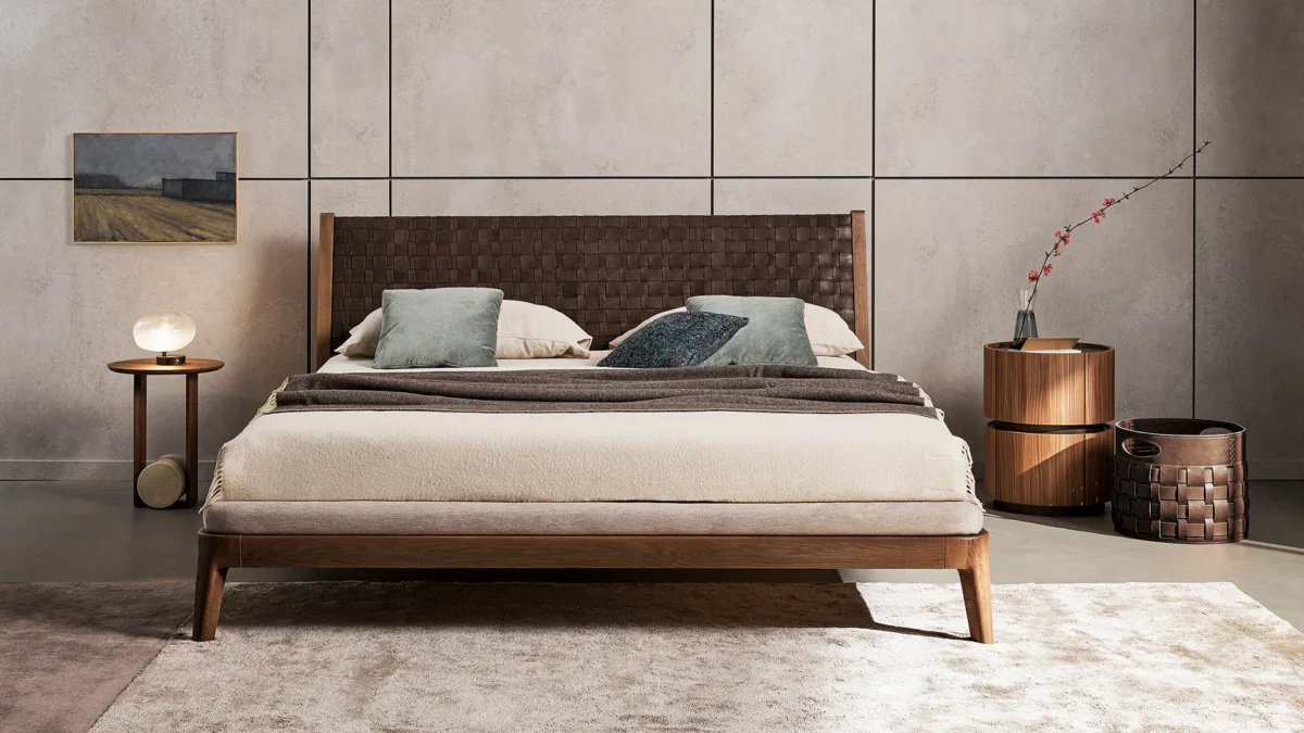 Bonaldo Honeymoon bed upholstered in fabric with rich walnut structure and hand‑woven leather panel