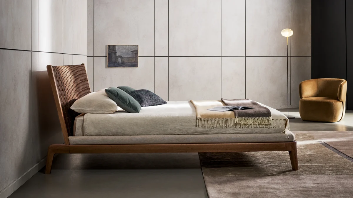 Elegant Bonaldo Honeymoon bed featuring American walnut frame and artisanal leather‑woven headboard